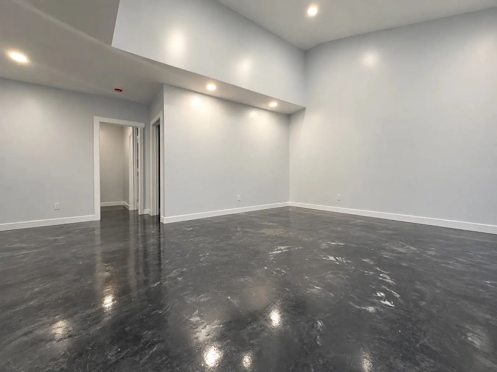A finished interior space with polished concrete flooring, built by Riverstone Builders