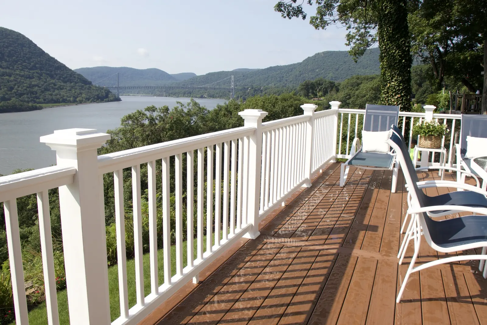 White vinyl deck railing and composite decking overlooking the Hudson River